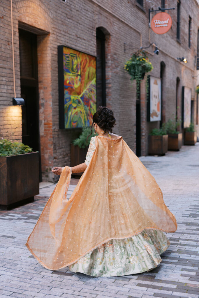 indian bride spins in her sari on her sangeet before her wedding day